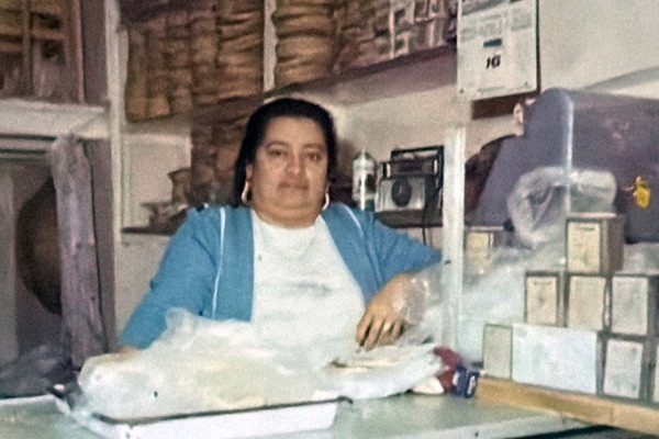 Old photo of Doña Manuela behind the counter of the family shop